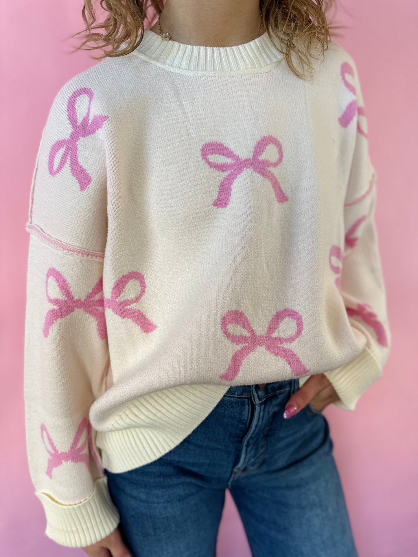 IVORY SWEATER WITH PINK BOW DETAIL